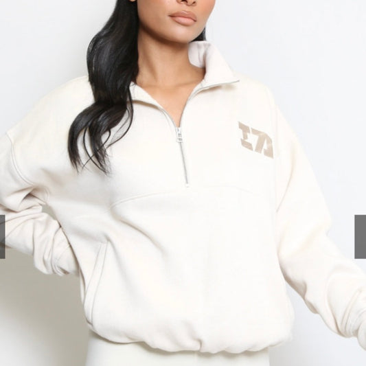 Cream iconic 1/4 zip sweater